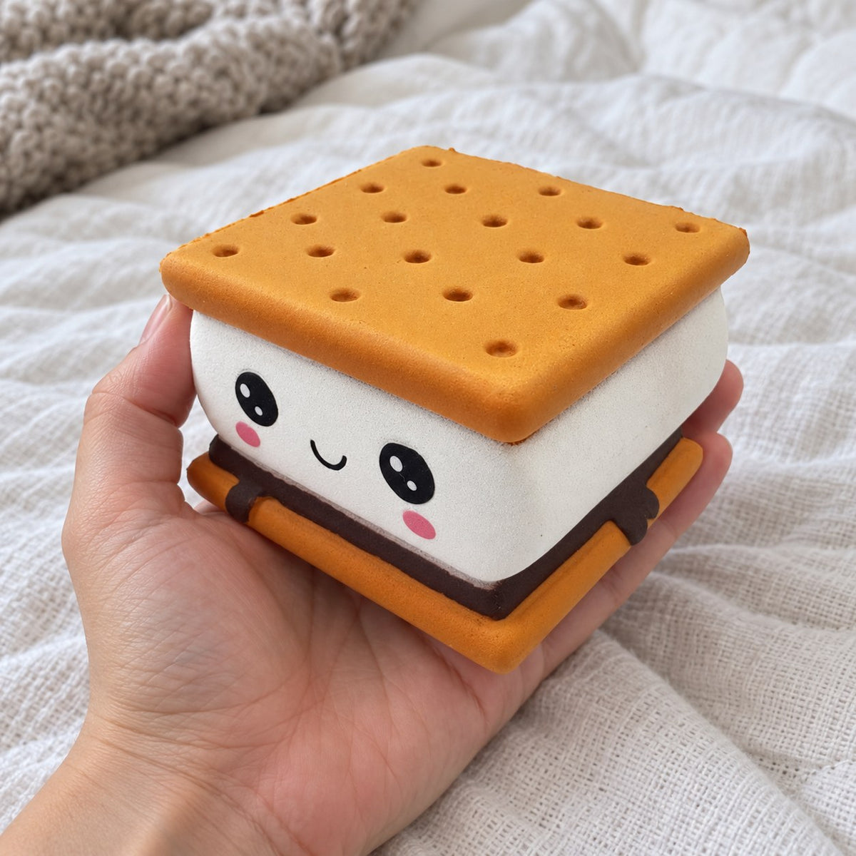 Cookie squishy, held toward the camera, first-person view
