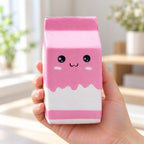Jumbo Milk Carton Squishy, Slow Rising (pink), held in a hand to show the real size