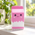 Milk carton squishy (pink), on a sunny windowsill