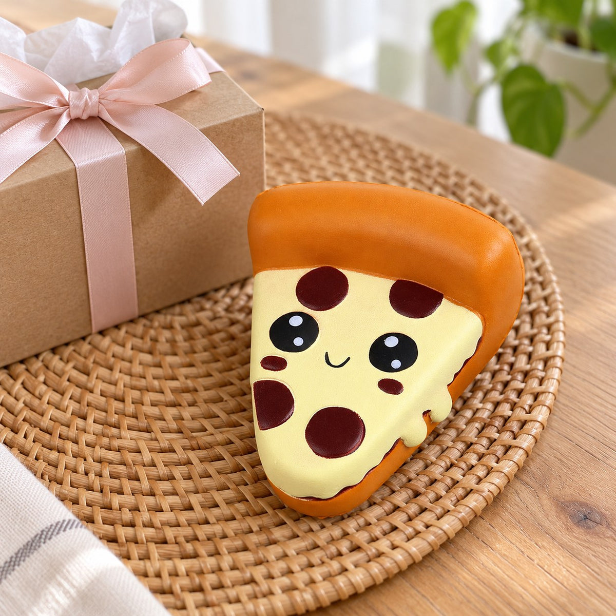 Jumbo Pizza Squishy, Kawaii Slice, as a small gift next to a wrapped box