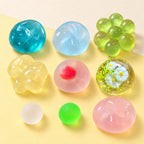 Maltose ball squishy set – Maltose Squishy Set, all 9 colors, product photo on pastel paper