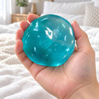 Maltose taffy squishy (Ocean Blue), held in a hand to show the real size