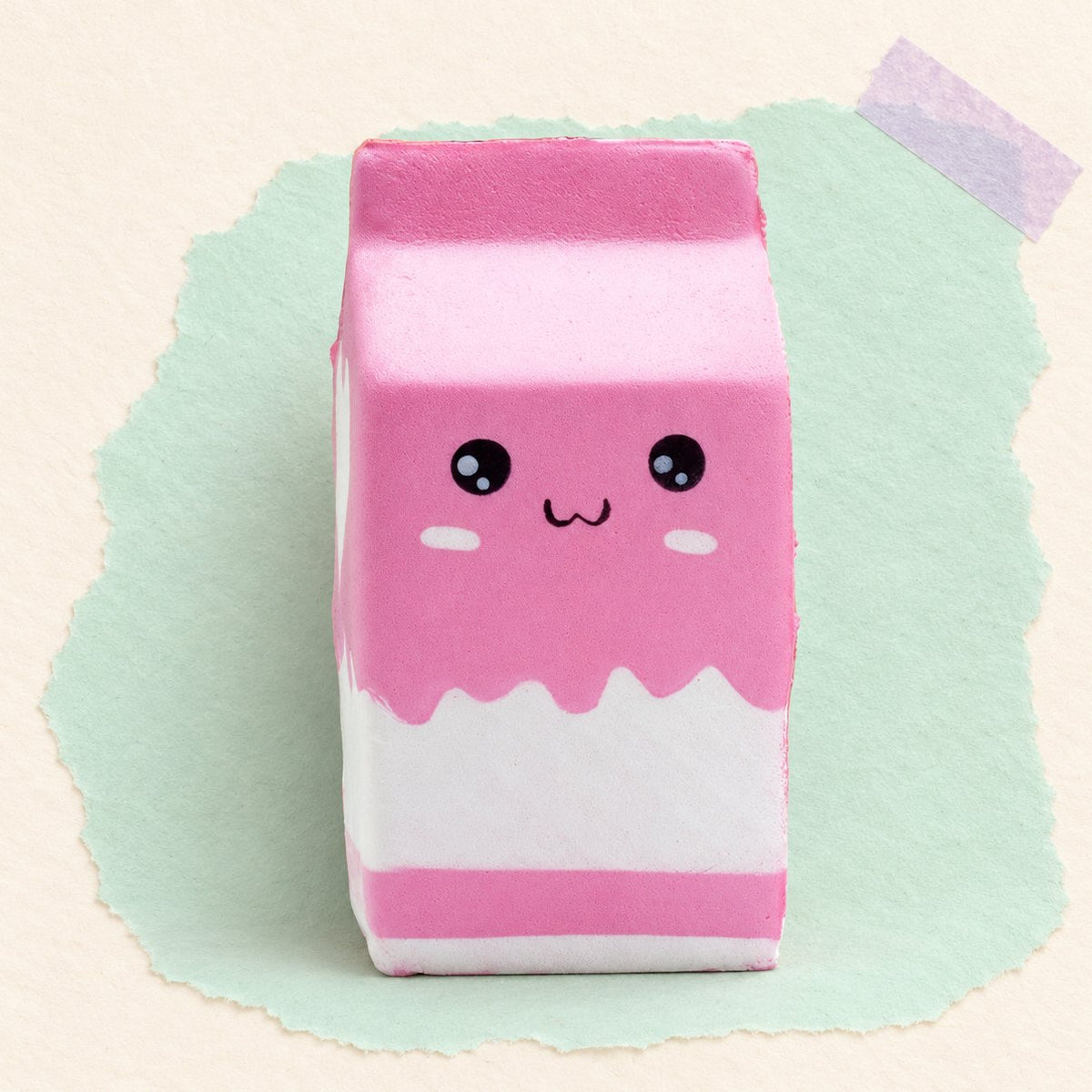 Roze melkpak squishy, jumbo en slow rising, op pastelkleurig papier
