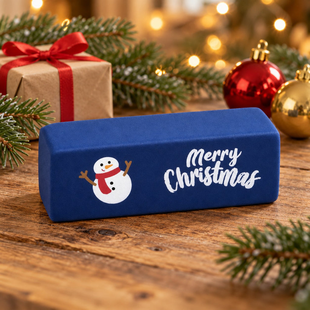Merry Christmas Butter Squishy, 6 Colors, Slow Rising (Dark blue, snowman), in a Christmas scene with fir branches and fairy lights