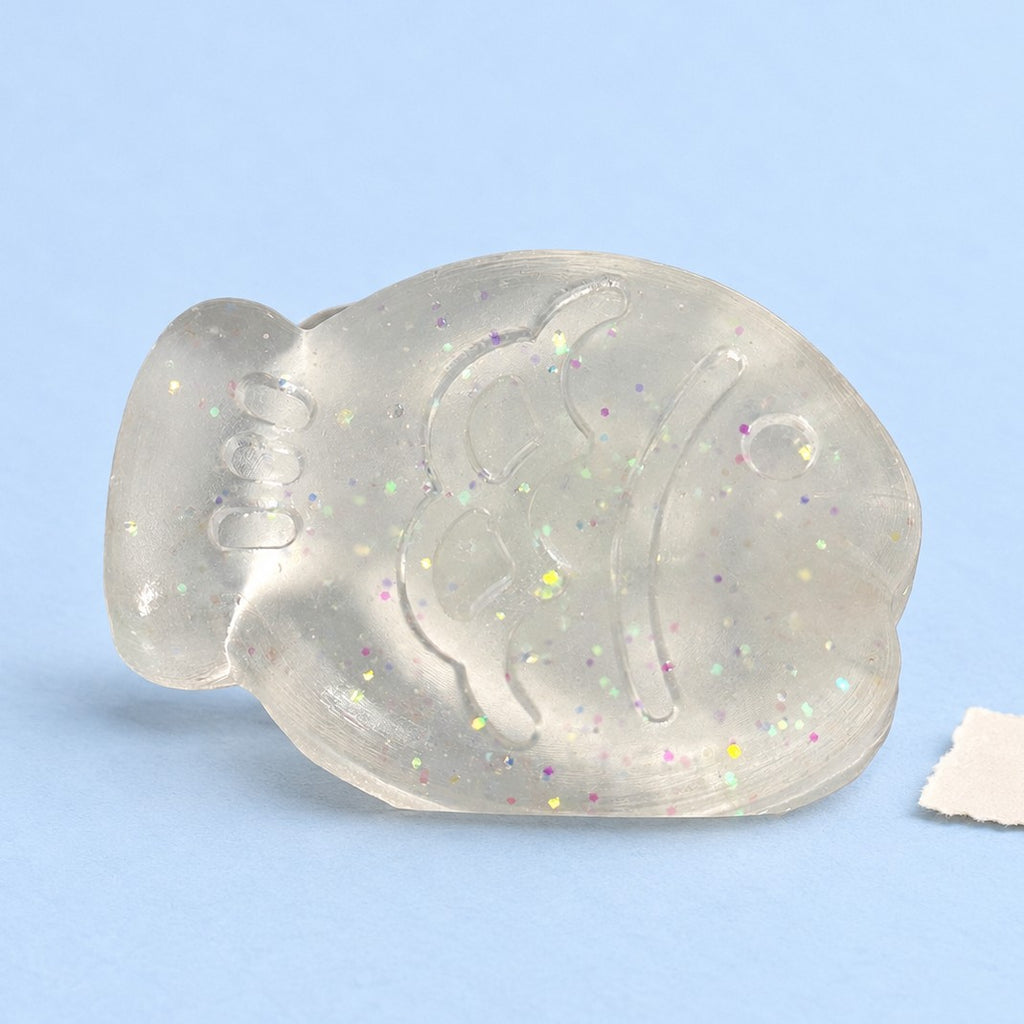 Fish squishy mini – Mini Jelly Fish Squishy, 6 cm (White glitter), product photo on pastel paper