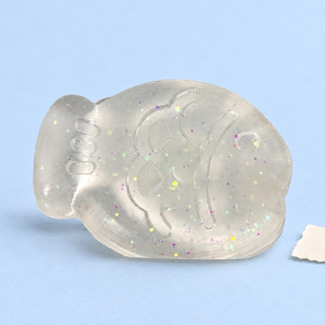 Fish squishy mini – Mini Jelly Fish Squishy, 6 cm (White glitter), product photo on pastel paper