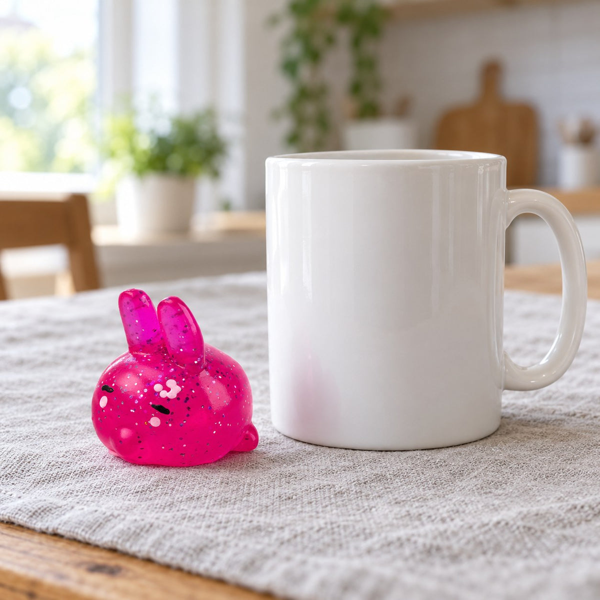 Bunny squishy, next to a coffee mug for size comparison
