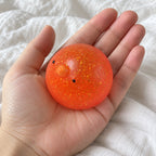 Chick squishy, held toward the camera, first-person view