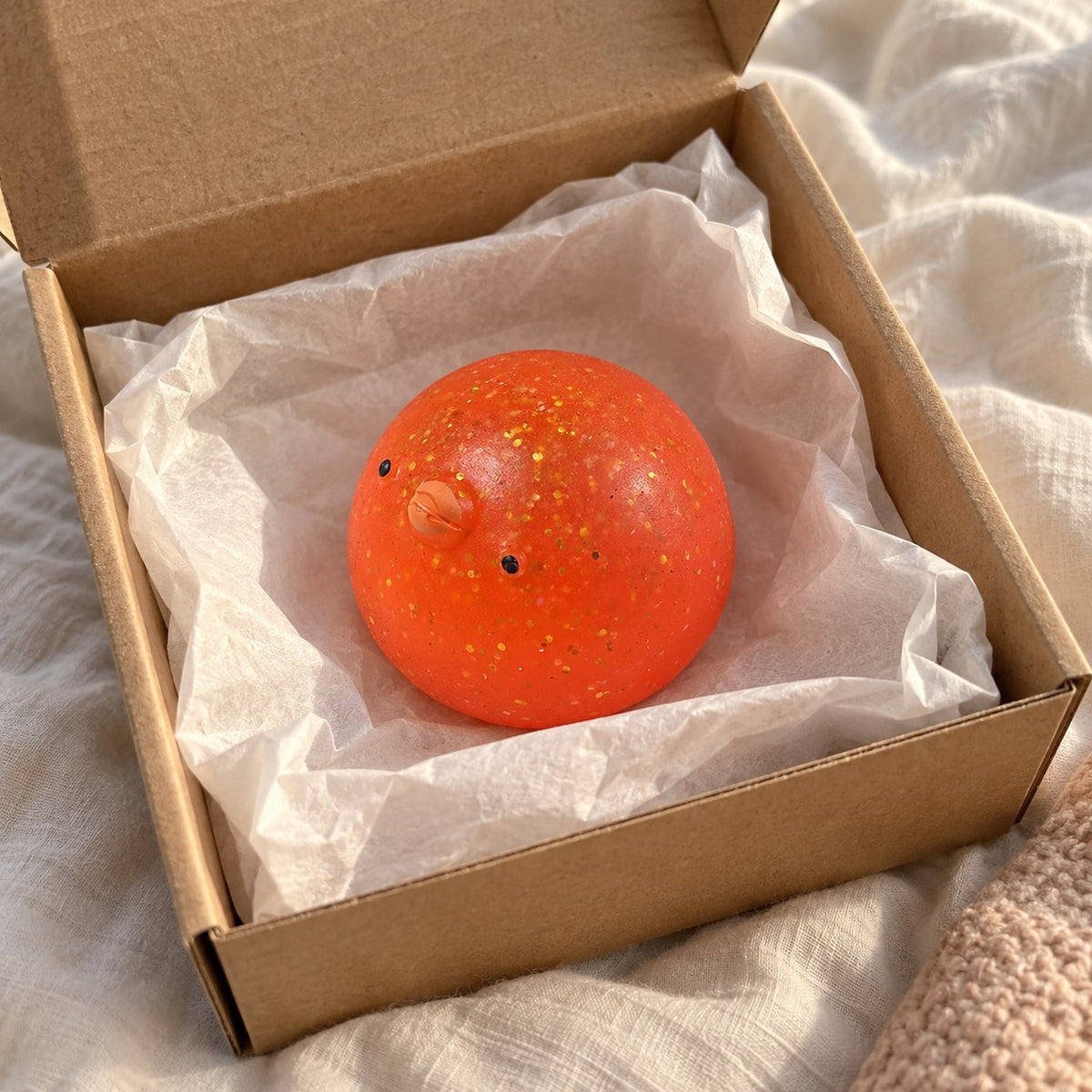 Chick squishy mochi, unboxed from a parcel with tissue paper