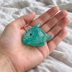 Big Mochi Squishy Dolphin with Glitter, held toward the camera, first-person view
