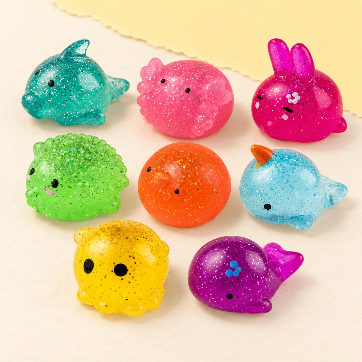 Mochi squishy glitter – Glitter Mochi Animal Squishies, all 8, product photo on pastel paper