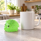 Hedgehog squishy mochi, next to a coffee mug for size comparison