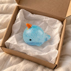 Narwhal squishy, unboxed from a parcel with tissue paper