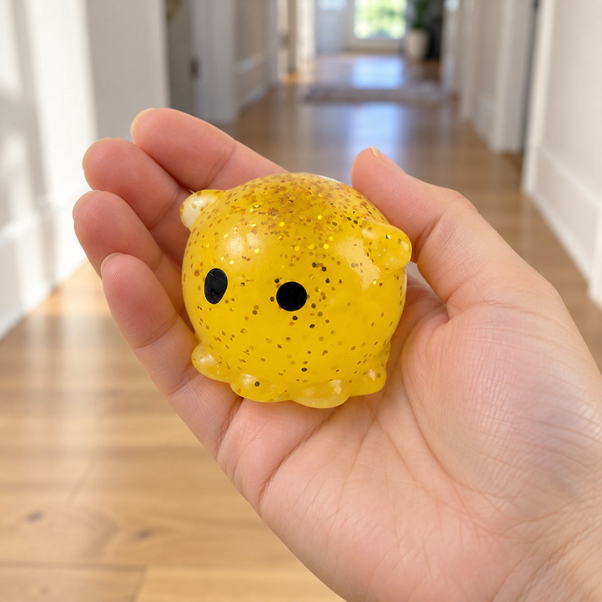 Mochi Squishy Octopus with Glitter, held in a hand to show the real size