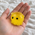 Octopus squishy mochi, held toward the camera, first-person view