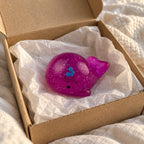 Mochi Squishy Whale with Glitter, unboxed from a parcel with tissue paper