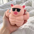 Muscle Pig Squishy with Sunglasses, 12.5 cm, held toward the camera, first-person view