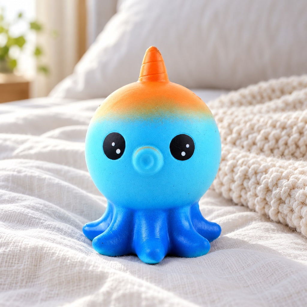 Octopus squishy, on a cozy bed with soft blankets
