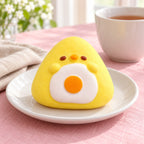 Onigiri Squishy, Yellow Chick with Fried Egg, on a plate on a breakfast table