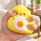 Onigiri Squishy, Yellow Chick with Fried Egg, being squeezed by hand, soft and squishy