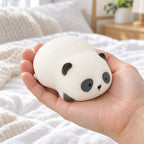 Panda Squishy, Lying Panda in Gift Box, held in a hand to show the real size