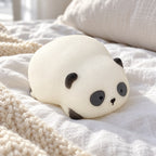 Panda Squishy, Lying Panda in Gift Box, on a cozy bed with soft blankets