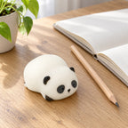 Panda Squishy, Lying Panda in Gift Box, on a desk with a notebook and pencil
