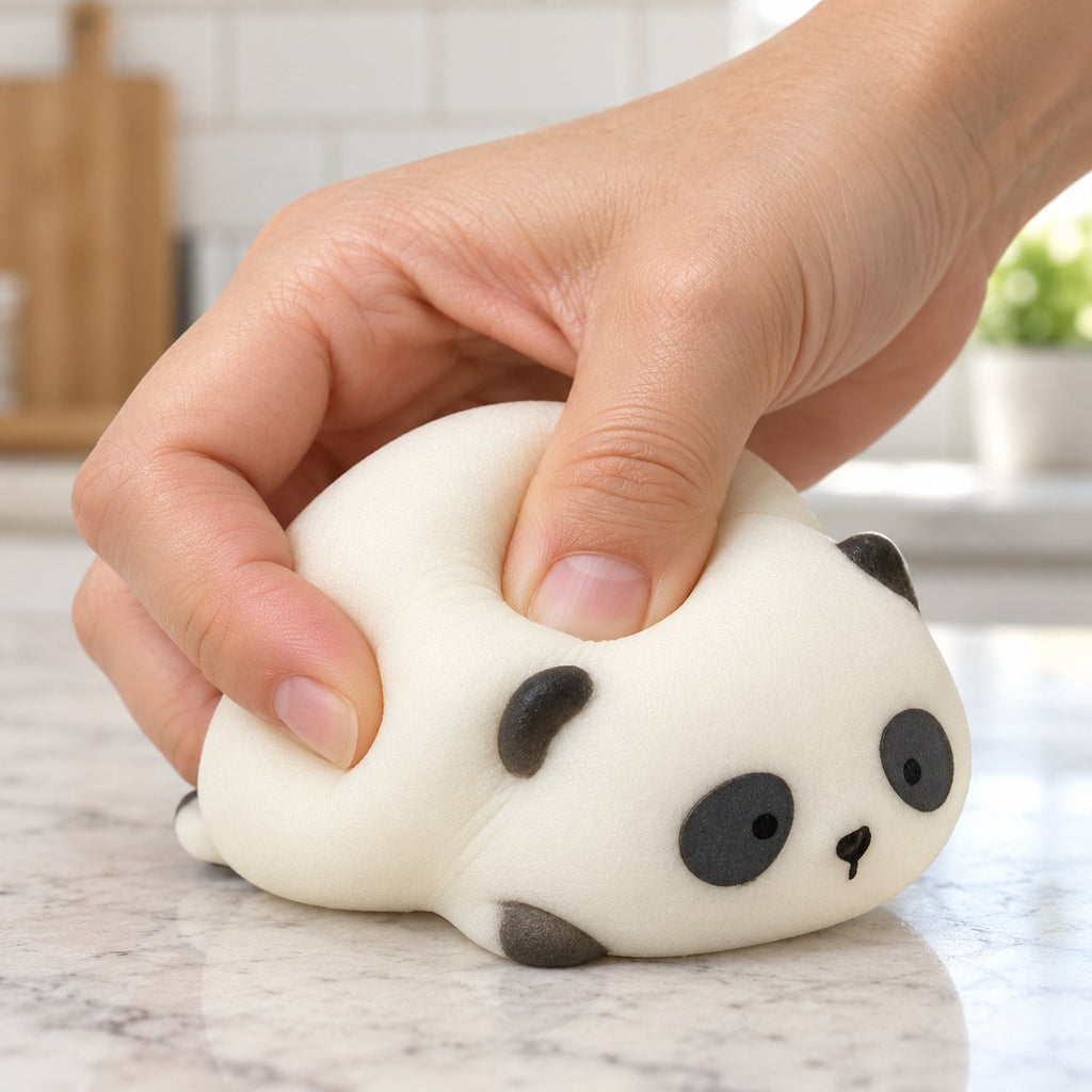 Panda Squishy, Lying Panda in Gift Box, being squeezed by hand, soft and squishy