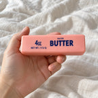 Pastel Butter Squishy, Pink, Strawberry or Chocolate, held toward the camera, first-person view