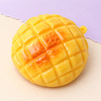 Pineapple bun squishy crunchy – Crunchy Pineapple Bun Squishy, 9 cm, product photo on pastel paper