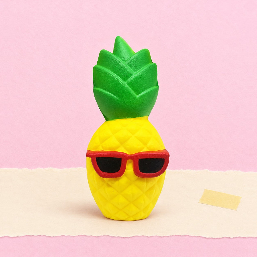 Pineapple squishy jumbo – Jumbo Pineapple Squishy with Sunglasses, product photo on pastel paper