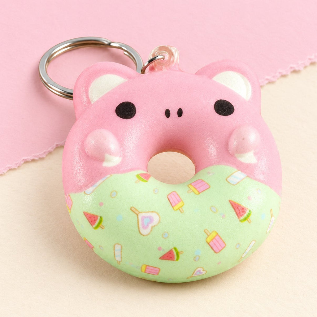 Donut sleutelhanger squishy met dierengezichtje, slow rising, op pastelkleurig papier