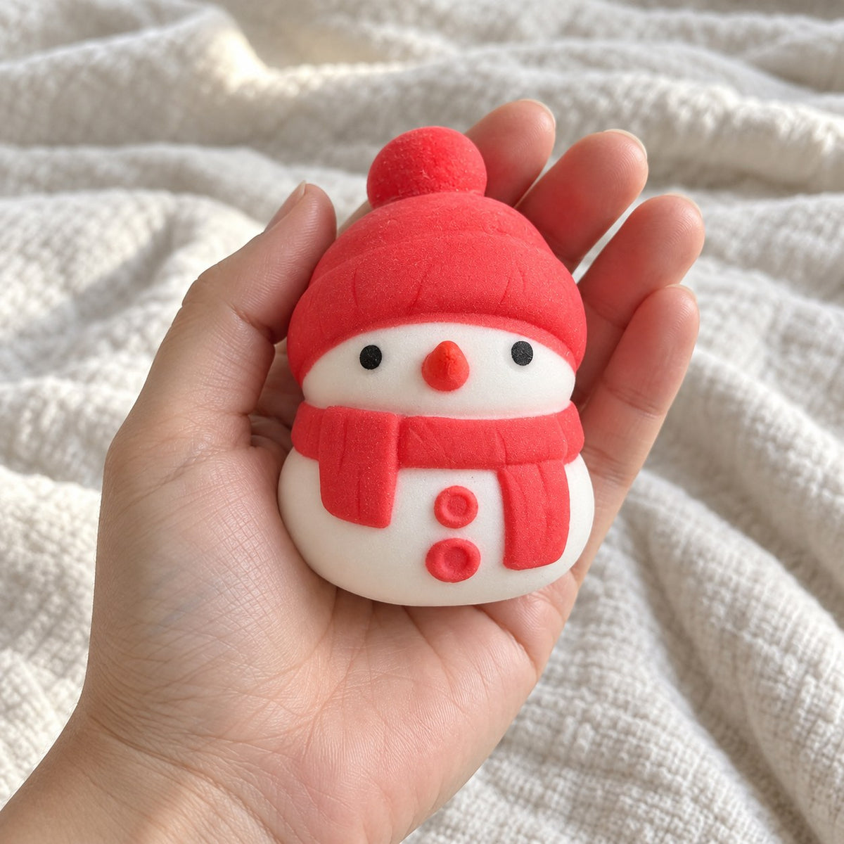 Snowman squishy christmas (red), held toward the camera, first-person view