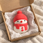 Snowman squishy (red), unboxed from a parcel with tissue paper
