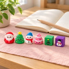 Squishy Advent Calendar with 24 Christmas Squishies, on a desk with a notebook and pencil