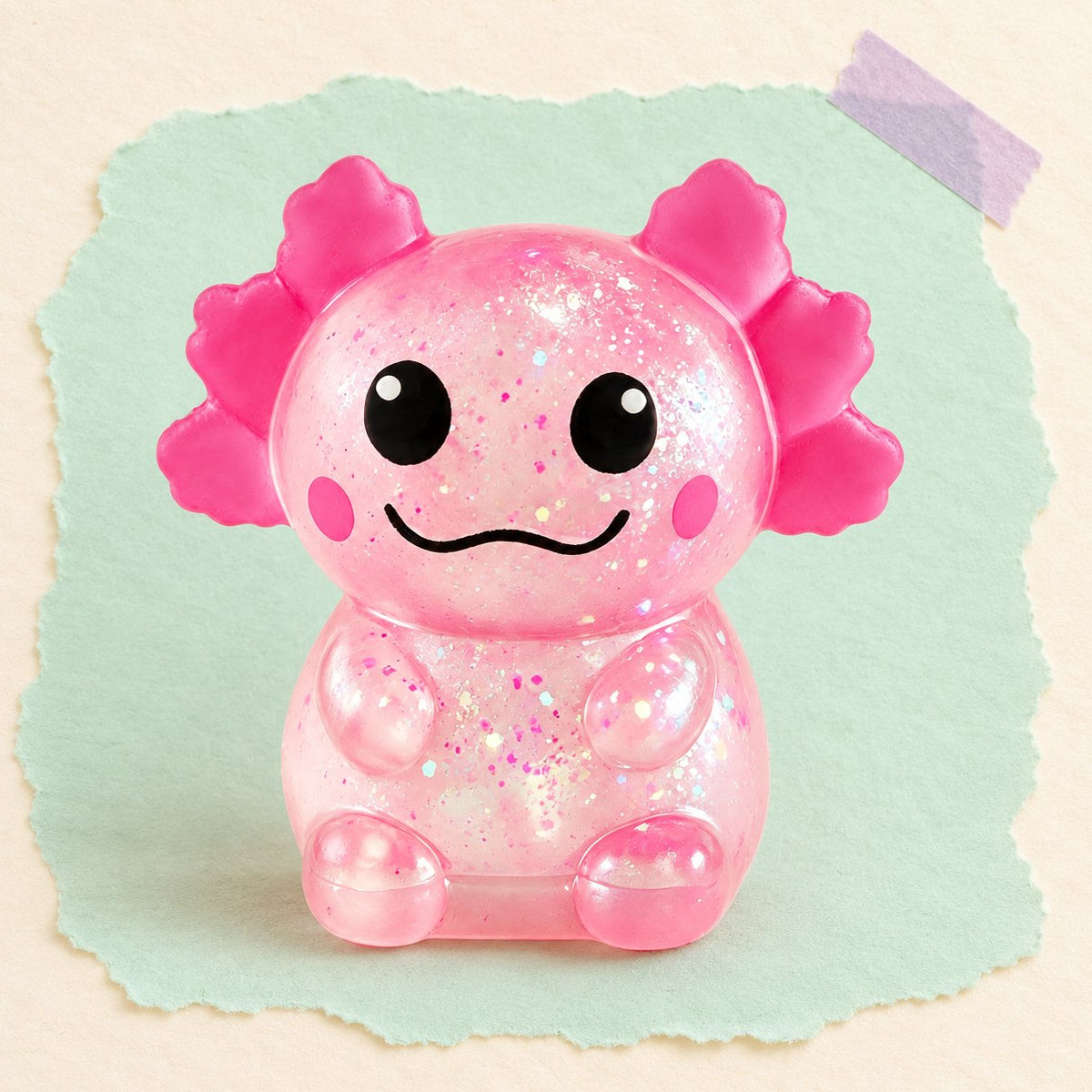 Squishy de ajolote con purpurina, slow rising, en rosa sobre papel pastel