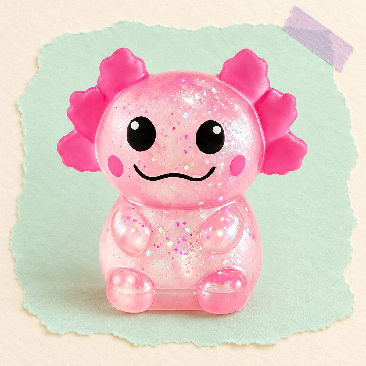 Squishy axolotl rosa con glitter, foto del prodotto su carta pastello