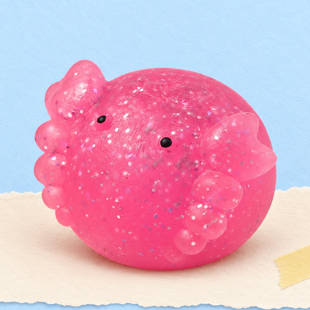 Squishy axolotl mochi pailleté, photo produit sur papier pastel