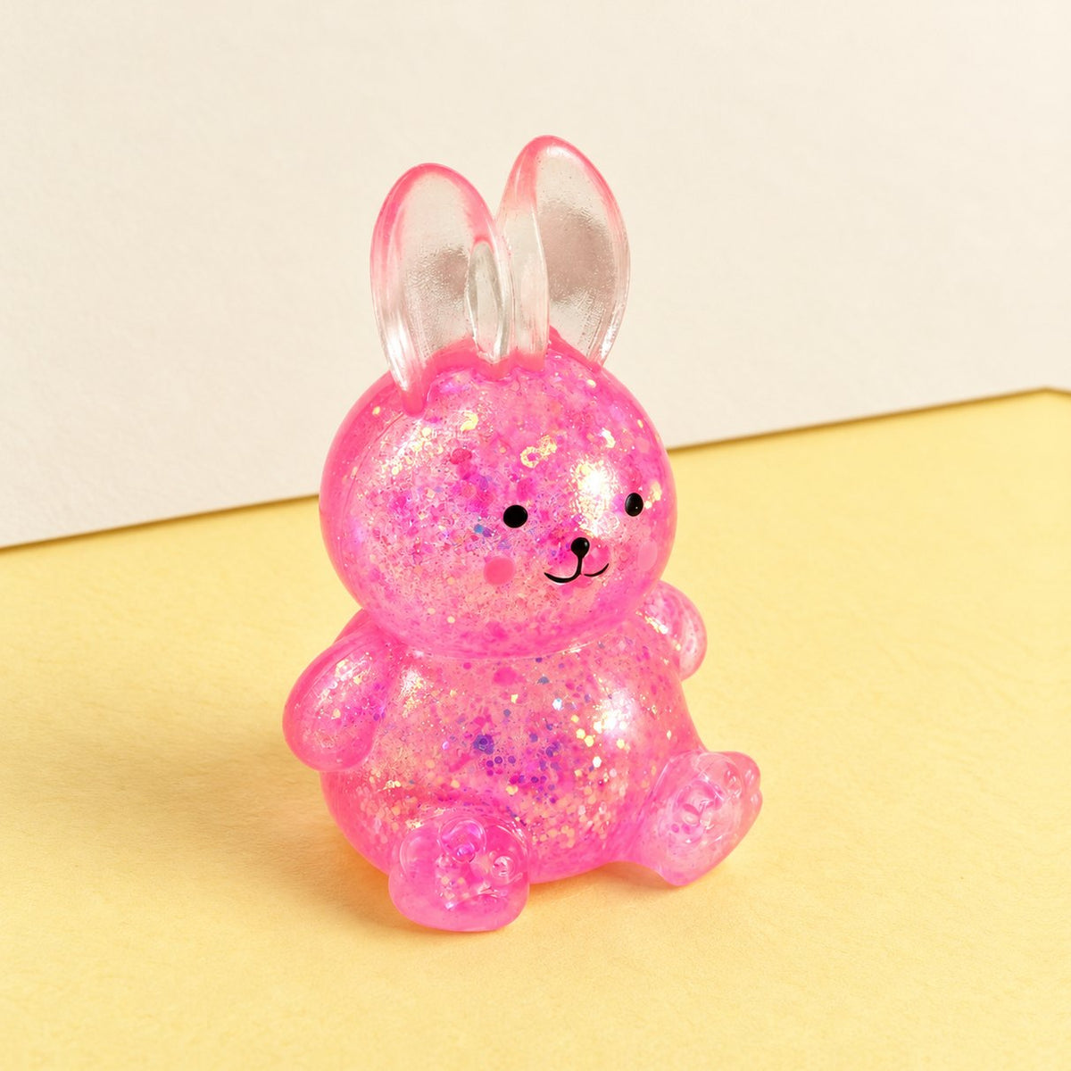 Squishy de conejo con purpurina, estilo sugar, sobre papel pastel