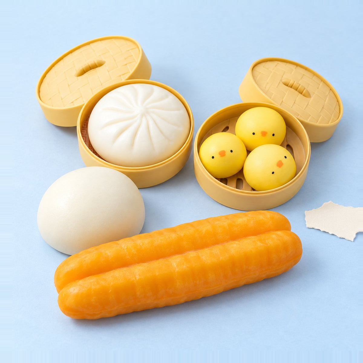 Conjunto de 4 squishies dumpling, sobre papel pastel