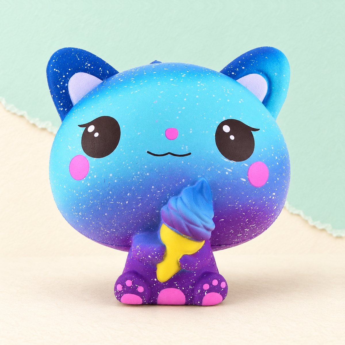 Squishy gato slow rising com gelado, perfumado, com motivo galáxia, sobre papel pastel