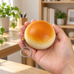 Squishy Keychain, Bread Bun Slow Rising, 4 or 7 cm (Golden bun, 7 cm), held in a hand to show the real size