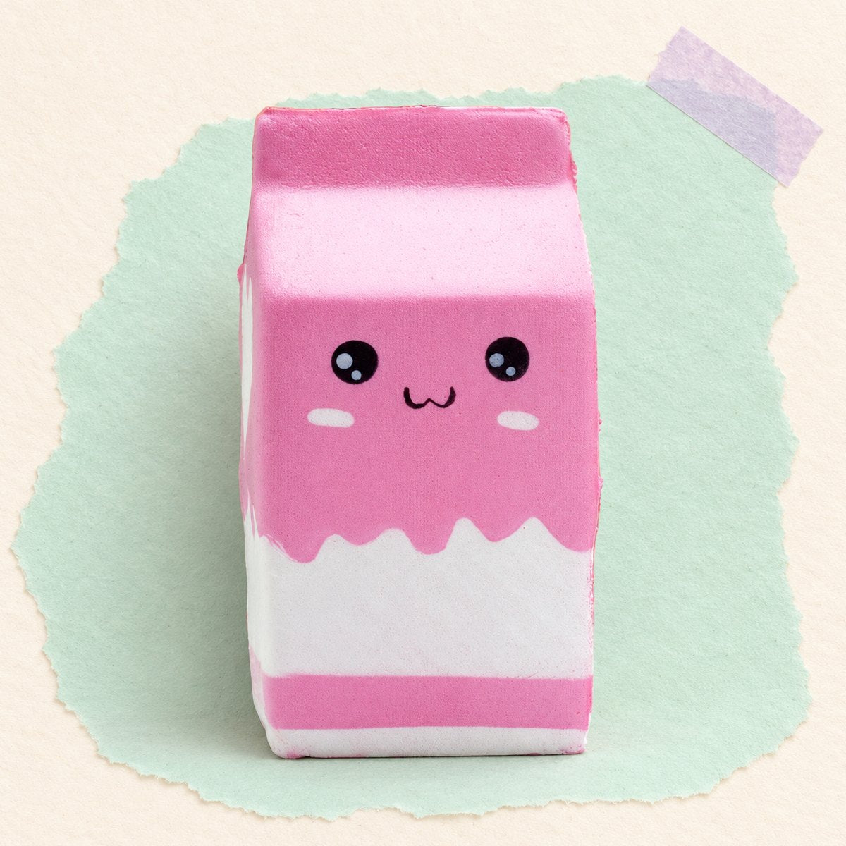 Squishy pacote de leite gigante e slow rising, em rosa, sobre papel pastel