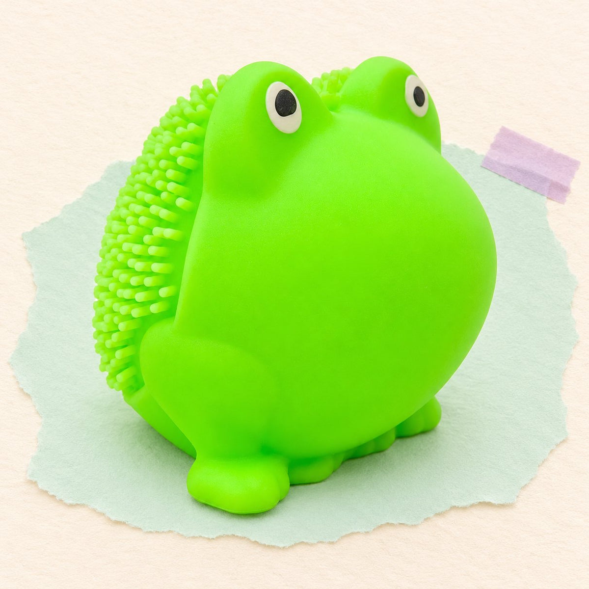 Squishy rana con spuntoni in TPR da 5 cm su carta color pastello