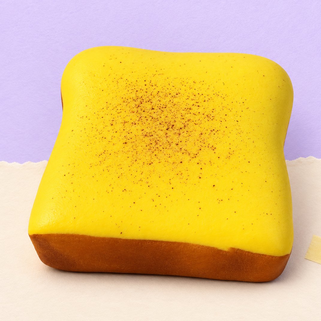 Squishy toast spesso giallo burro, fetta cuscino da 11 cm, su carta pastello