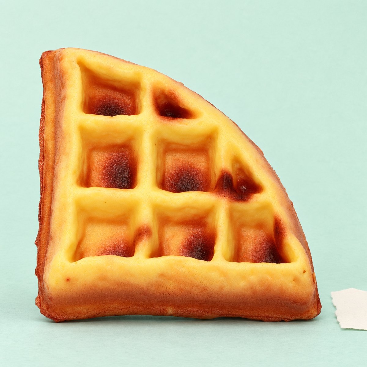 Squishy waffle slow rising, fatia triangular de 11 cm, sobre papel pastel