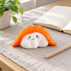 Sushi squishy soft, on a desk with a notebook and pencil
