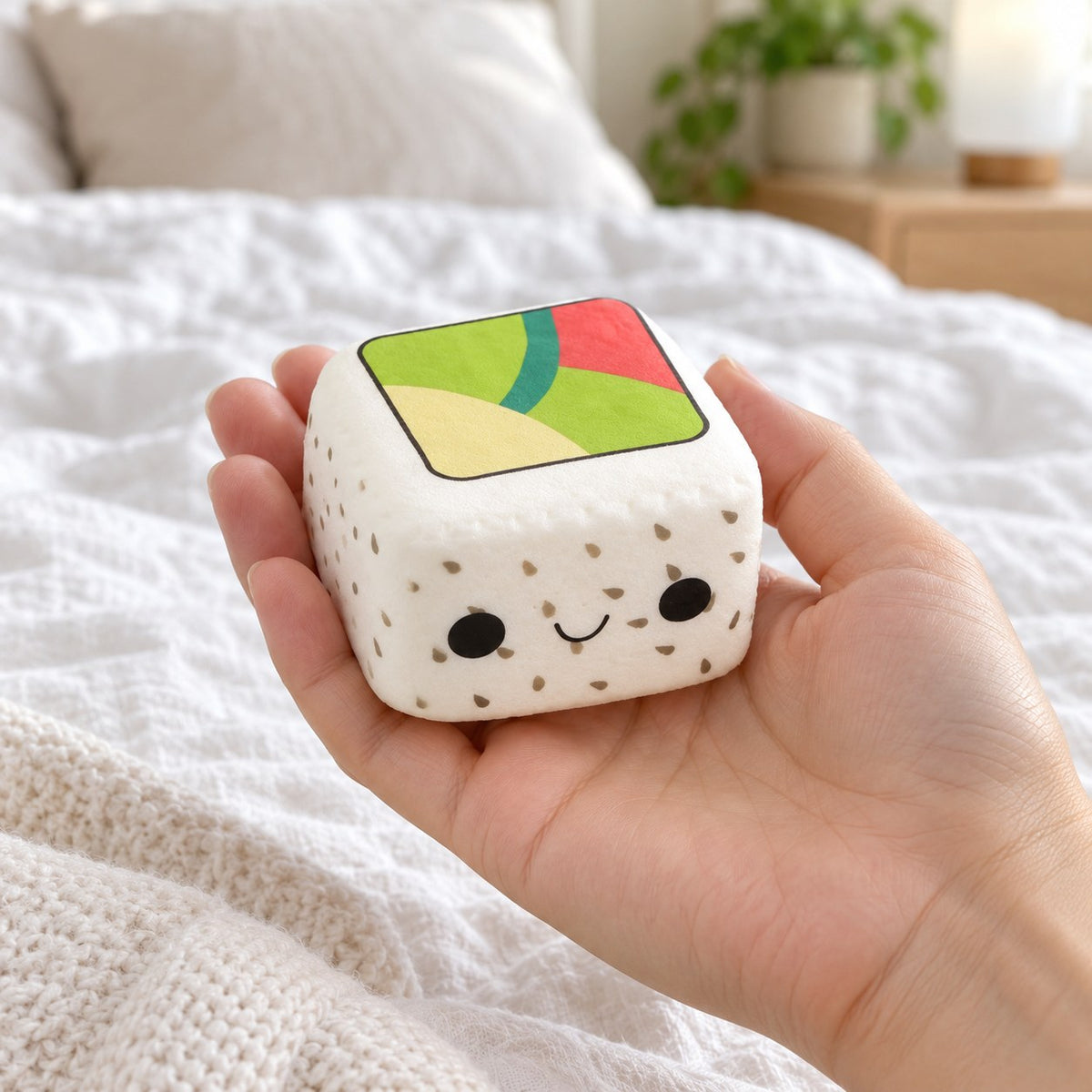 Kawaii Sushi Squishy, Slow Rising (White Rice, Black Sesame), held in a hand to show the real size