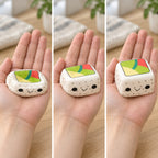 Sushi squishy (White Rice, Black Sesame), squished flat, half risen and fully back in shape