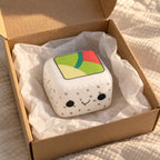 Sushi squishy slow rising (White Rice, Black Sesame), unboxed from a parcel with tissue paper